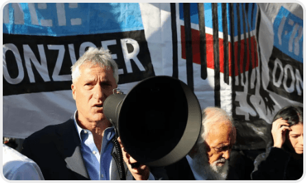 Steven Donziger speaking through a loudhailer at a protest